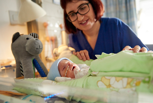 Paediatric nurse with baby in PICU