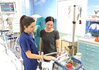 Matron Jo Tillman discusses patient details with staff nurse Esther Dominguez Verde