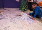 Seven-year-old patient Alihan puts the last signature on the card