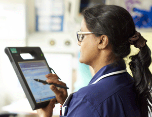 A nurse lookind at an ipad