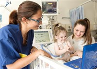 PICU nurse with patient