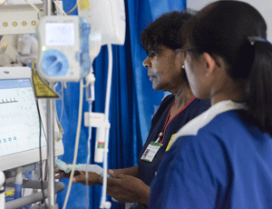 Two nurses looking at a monitor