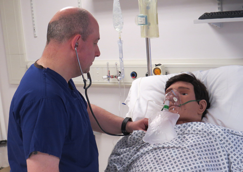 Andrew Sykes prepares the mannequin for a training session 