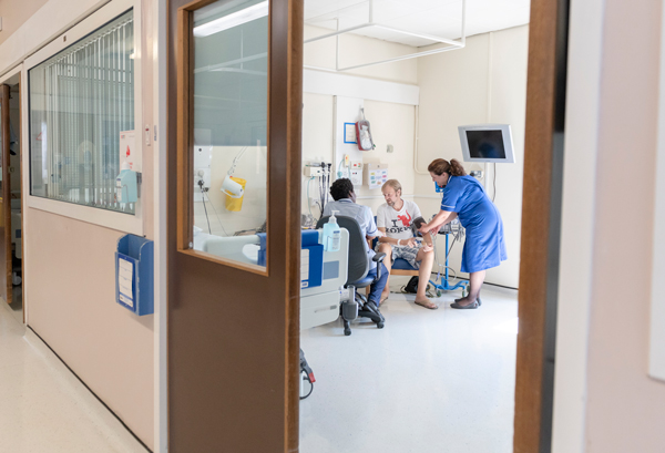 Patient speaking to nurses on a ward