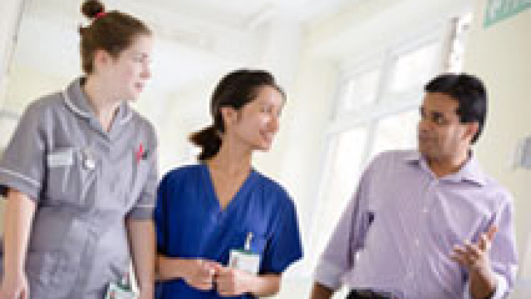 Hospital staff walking down a corridor